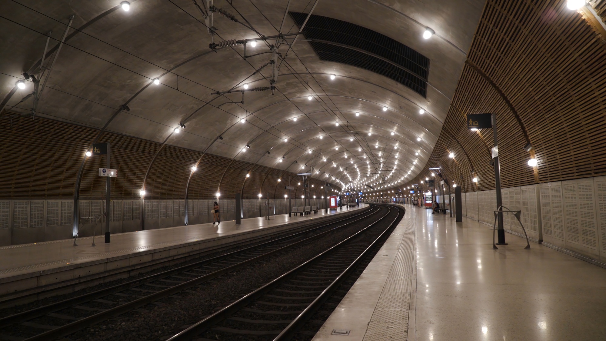 Underground subway tunnel with bright lighting. Action. Simple stone interior of underground metro